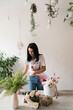 © Natalia - brunette girl making a bouquet of flowers on the table florist at work