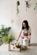© Natalia - brunette girl making a bouquet of flowers on the table florist at work