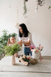 © Natalia - little girl helps mom florist to collect a bouquet of flowers at the table