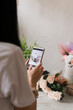 © Natalia - phone in female hands photographs a bouquet of flowers
