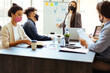 © kleberpicui - Business team wearing protective masks while meeting in the office during the COVID-19 epidemic