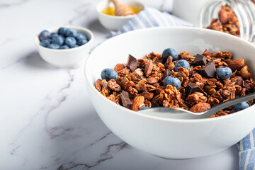 Canvas Print - Homemade granola, muesli with pieces of dark chocolate, nuts and blueberries