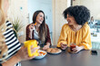 © nenetus - Three smart entrepreneur women talking while taking a break and having a breakfast in the kitchen at coworking place.