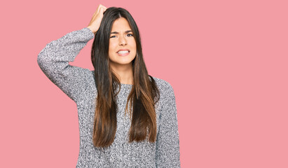 Poster - Young brunette woman wearing casual winter sweater confuse and wonder about question. uncertain with doubt, thinking with hand on head. pensive concept.