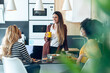 © nenetus - Three smart entrepreneur women talking while taking a break and having a breakfast in the kitchen at coworking place.