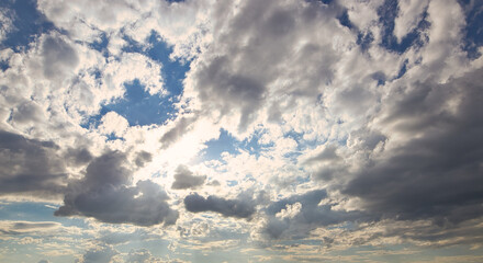 Wall Mural - dramatic blue sky with rays and white clouds