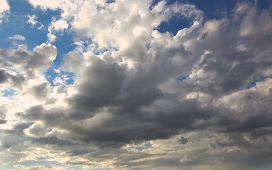 Wall Mural - dramatic blue sky with rays and white clouds