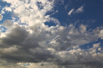 Wall Mural - dramatic blue sky with rays and white clouds