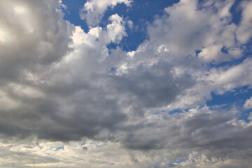 Wall Mural - dramatic blue sky with rays and white clouds