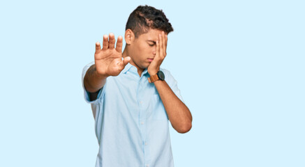 Canvas Print - Young handsome african american man wearing casual clothes covering eyes with hands and doing stop gesture with sad and fear expression. embarrassed and negative concept.