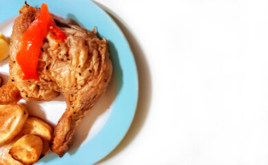 Sticker - Cooked chicken leg and roasted Spanish potatoes. Plate on white background. Overhead shot. Copyspace