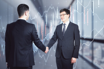 Poster - Deal and business partnership concept with businessmen handshaking on digital screen with financial chart and diagram background