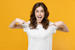 © ViDi Studio - Young happy smiling surprised excited positive fun caucasian student woman in white basic blank print design casual t-shirt point index finger on herself isolated on yellow background studio portrait.