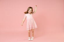 Full Length Of Little Kid Girl 5-6 Years Old Wears Rosy Dress Have Fun Dancing Fooling Around Celebrate Play Isolated On Pastel Pink Background Child Studio Portrait. Mother's Day Love Family Concept.