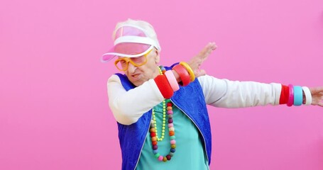 Wall Mural - Footage of a funny grandmother with fashionable look acting on colored backgrounds