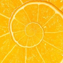 Spiral Fractal Mandarin Orange Fruit. Top View Of Textured Ripe Slice Of Mandarin Orange Citrus Fruit With Spiral Endless Skin. Endless Juicy Orange Citrus Fruit. Sea Of Juice Concept.