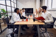 © Roman - Concentrated business people communicating with each other while working together in the board room