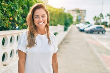 Poster - Beautiful middle age hispanic woman smiling happy outdoors