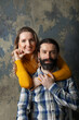 © BY-_-BY - Happy adult couple hugging, smiling wide and looking at camera