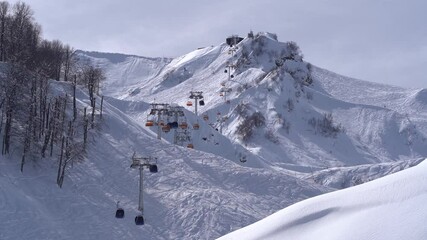 Wall Mural - Timelapse with ski cabins and moving clouds at the at the Alpika Ski Resort in Krasnaya Polyana, in Russia.