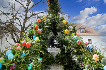 Easter is a religious festival with colored eggs and decorated bushes and fountains