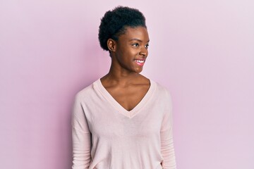 Poster - Young african american girl wearing casual clothes looking to side, relax profile pose with natural face and confident smile.