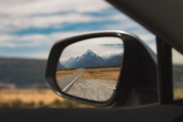 view of mount cook new zealand in the rear view mirror. end of journey. traveling is over