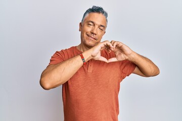 Poster - Handsome middle age mature man wearing casual clothes smiling in love showing heart symbol and shape with hands. romantic concept.