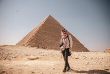 Epic Travel Shot Of A Young Man Walking In Front Of The Pyramids Of Giza