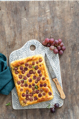 Sticker - Top view of homemade sweet cakes with red grapes on a board