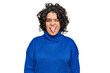 © Krakenimages.com - Young hispanic woman with curly hair wearing turtleneck sweater sticking tongue out happy with funny expression. emotion concept.