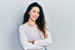 © Krakenimages.com - Young hispanic woman wearing casual clothes happy face smiling with crossed arms looking at the camera. positive person.