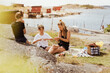 © Maskot - Mother making craft with children by harbor during summer vacation