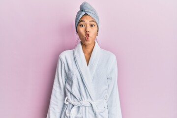 Sticker - Young chinese woman wearing shower towel cap and bathrobe making fish face with lips, crazy and comical gesture. funny expression.