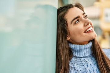 Young hispanic girl smiling happy standing at the city