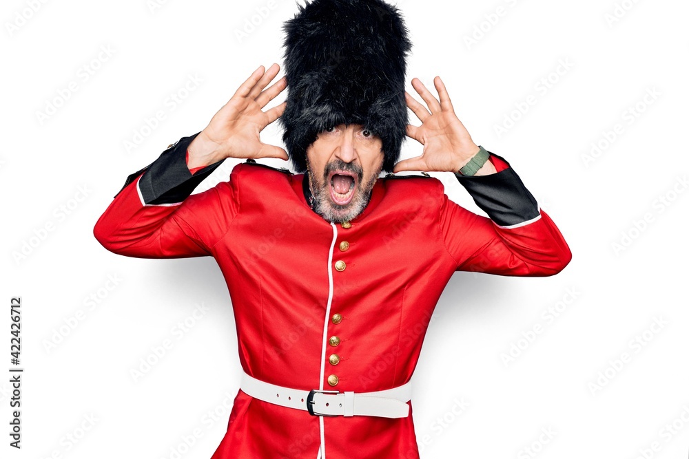 Middle age handsome wales guard man wearing traditional uniform over ...