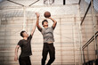 © imtmphoto - young asian men playing basketball outdoors