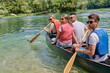 © .shock - Group adventurous explorer friends are canoeing in a wild river