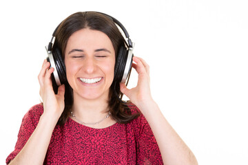 Wall Mural - young woman enjoys musicians music in headphones on white background