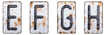 3D render set of capital letters E, F, G, H made of forged metal on the background fragment of a metal surface with cracked rust.