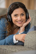 © auremar - woman in headphones smiling listening to music