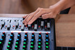 © lmanju - lady adjust volume on mixing board