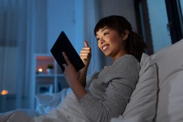 Sticker - woman with tablet pc in bed has video call at night