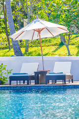 Wall Mural - Umbrella and chair around outdoor swimming pool in hotel resort