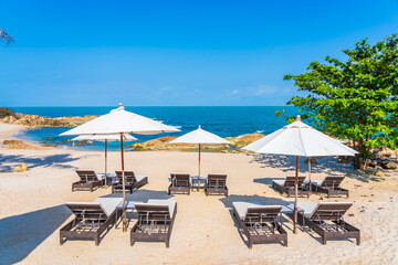 Wall Mural - Beautiful tropical beach sea with umbrella and chair around white cloud and blue sky