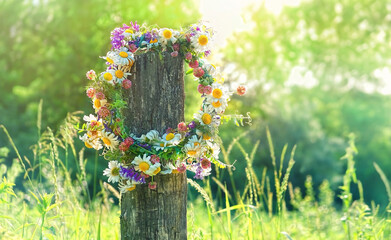 Canvas Print - rustic wildflowers wreath on sunny meadow. Summer Solstice Day, Midsummer concept. floral traditional decor. pagan witch traditions, wiccan symbol and rituals.