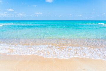 Wall Mural - Beautiful tropical beach sea ocean with white cloud and blue sky