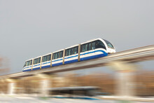 High Speed Subway Train On The Air Bridge Travels At High Speed Over City Streets.