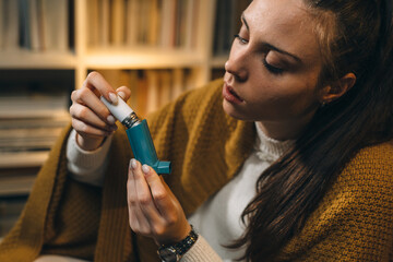 woman using asthma pump. close up .