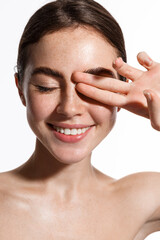 vertical shot of beauty woman naked, touching fresh and clean, hydrated facial skin, close eyes and 